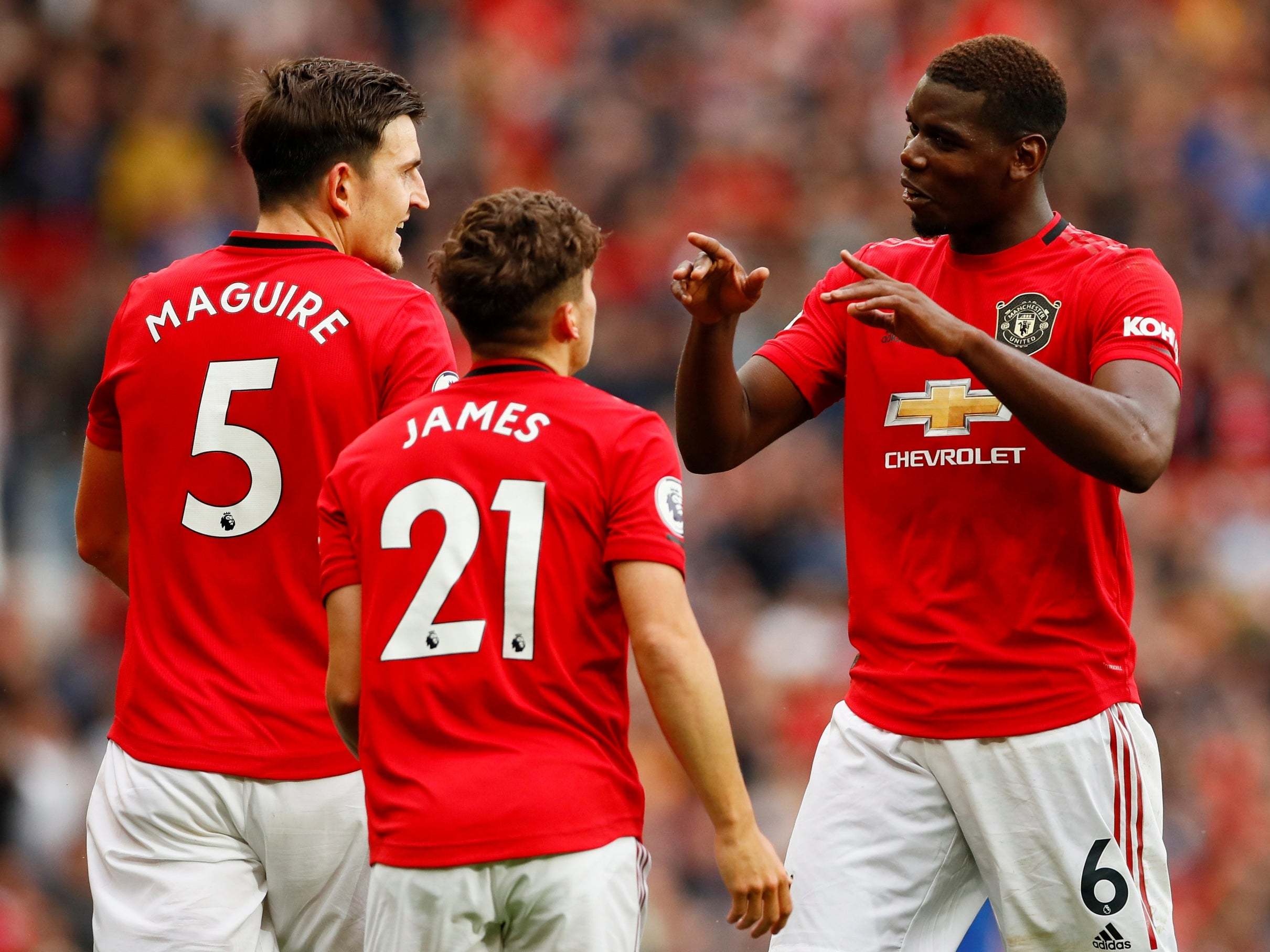 Paul Pogba celebrates after setting up Daniel James' debut goal