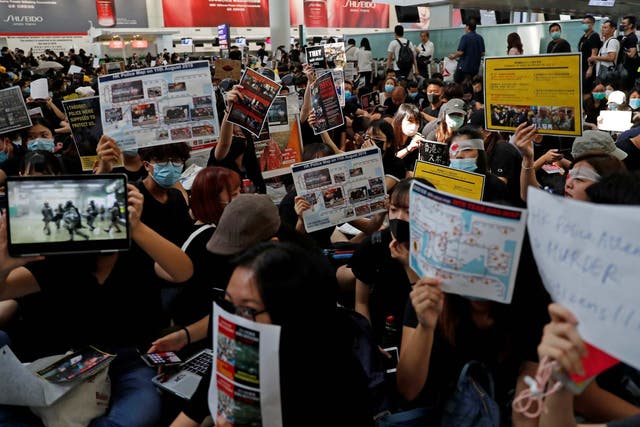 Anti-government protesters hold a mass demonstration at Hong Kong International Airport