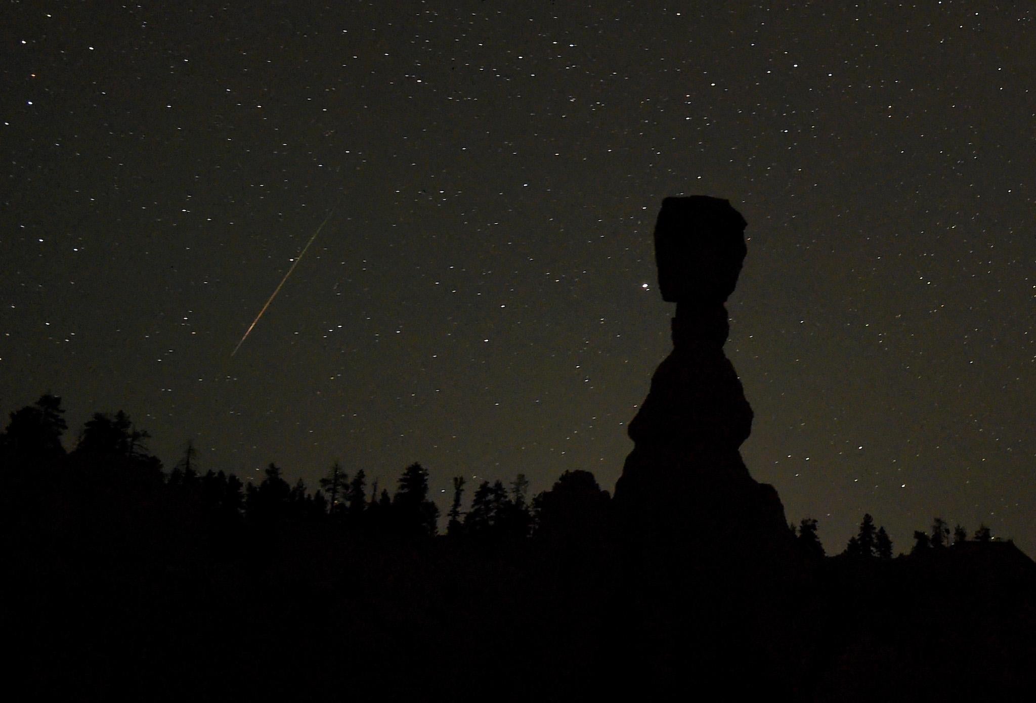 A Perseid meteor streaks across the sk early on August 13, 2016 in Bryce Canyon National Park, Utah
