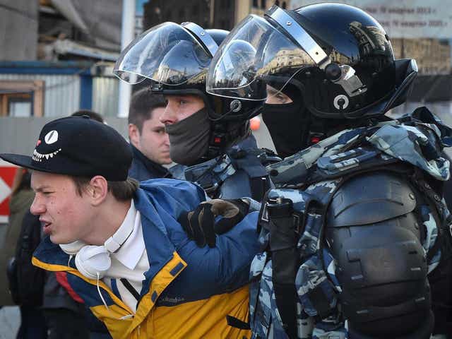 Russian special police forces detain a protester after a rally in Moscow urging fair elections