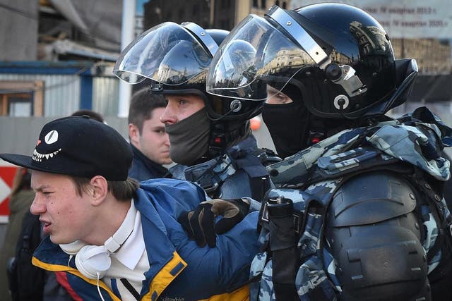 Russian special police forces detain a protester after a rally in Moscow urging fair elections