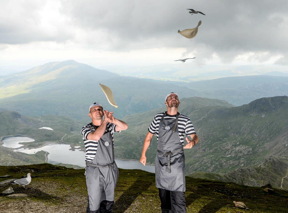Pizza Express managers flared dough at the top of Snowdon to raise money for a cancer charity