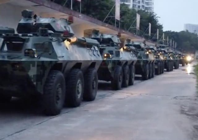 Video posted by Chinese state media purporting to show troops assembling near the border with Hong Kong