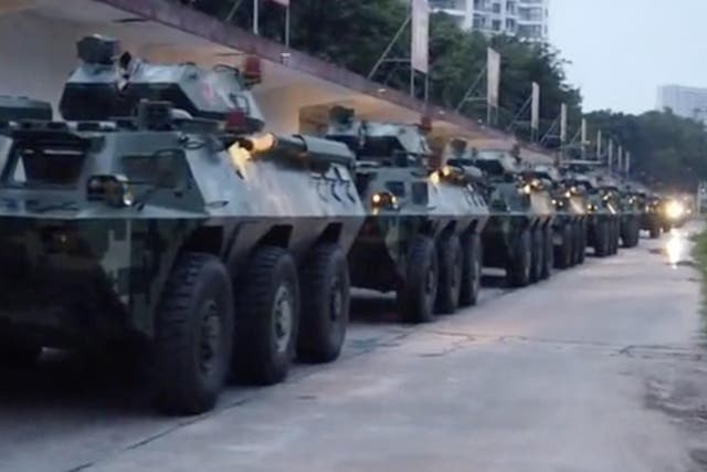 Video posted by Chinese state media purporting to show troops assembling near the border with Hong Kong