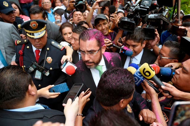 Mexico's security minister Jesus Orta Martínez was enveloped in pink glitter when he tried to reassure the women both cases would be properly investigated