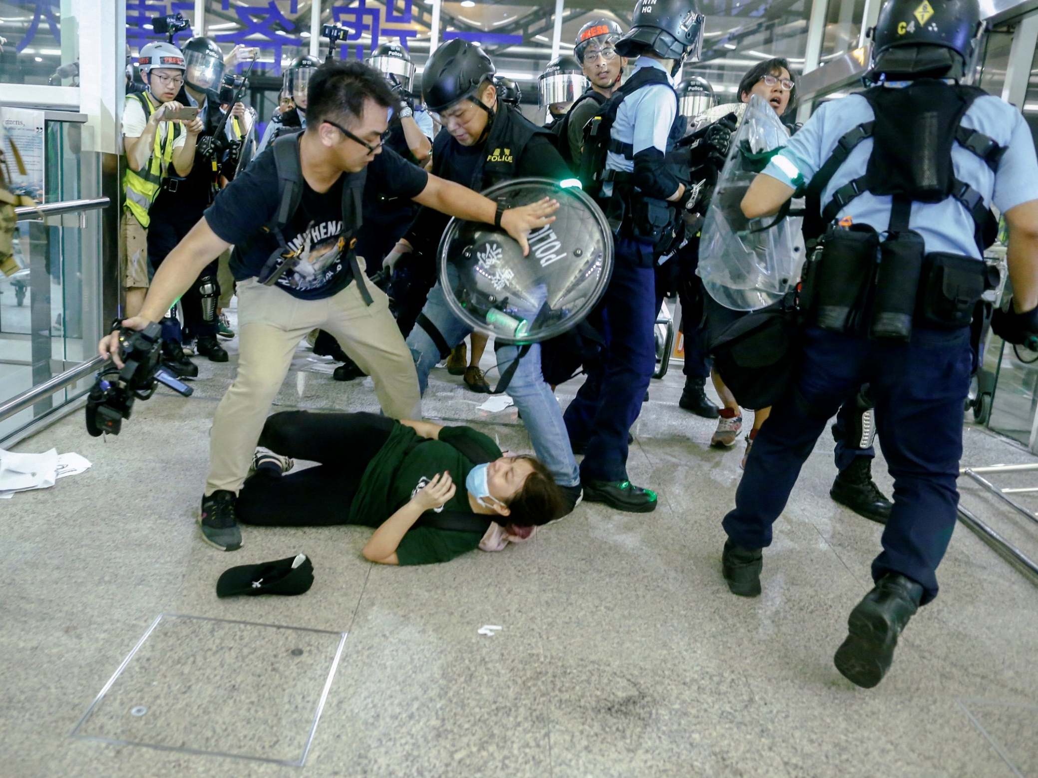 Hong Kong protests - live: Violent clashes break out at airport as riot police begin crackdown on demonstrators