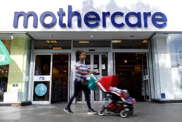 Shoppers walk past a Mothercare shop on Wood Green High Street in north London on June 19, 2018