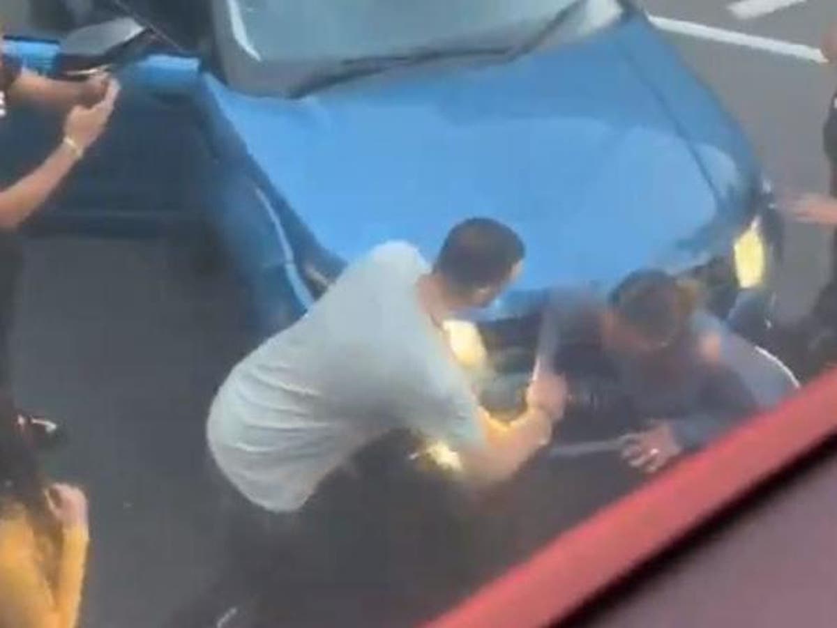 Woman trapped between two cars in 'road rage' crash