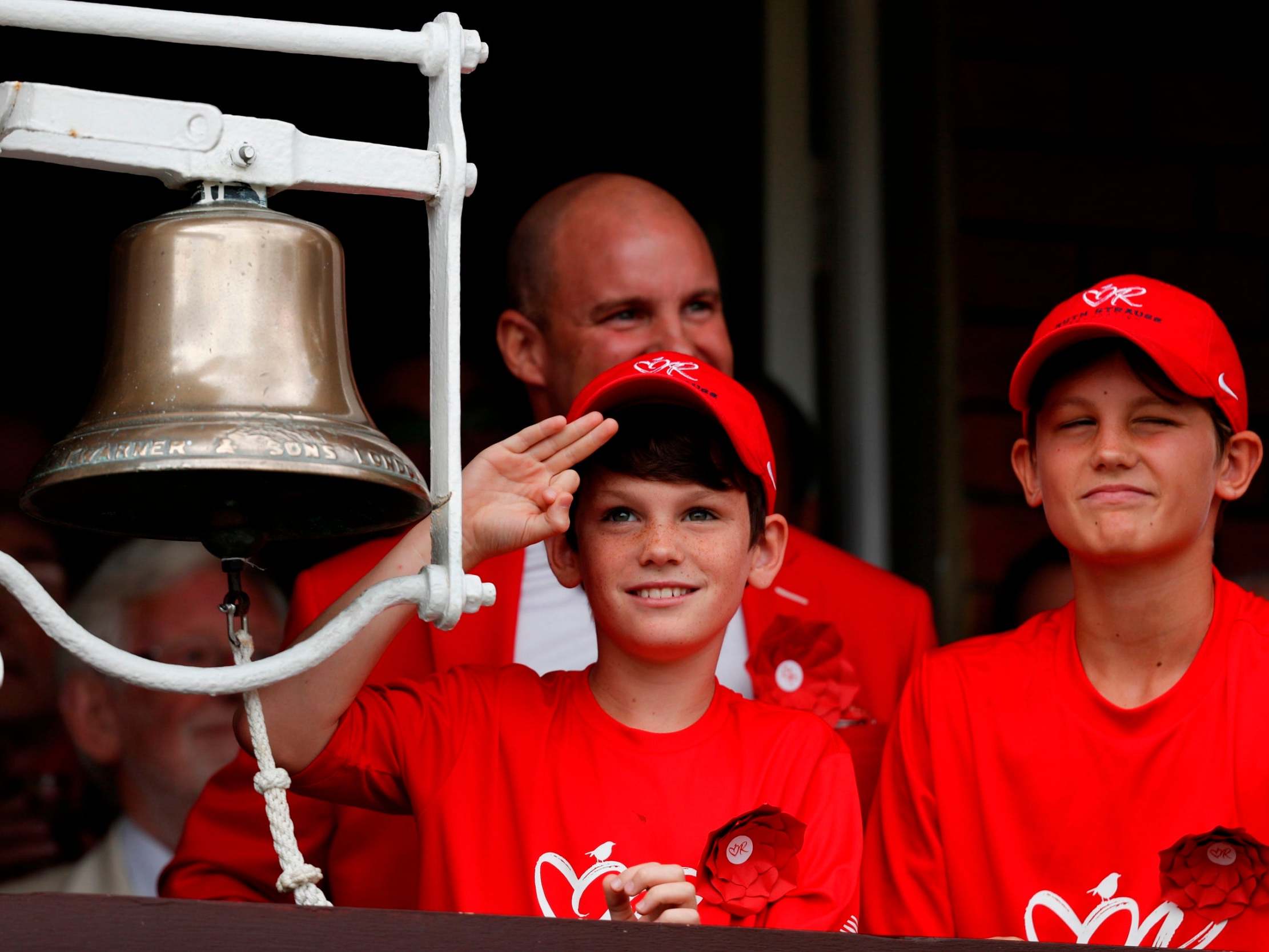 Andrew Strauss (back) and his two sons Luca (l) and Sam (r) ring the five-minute bell