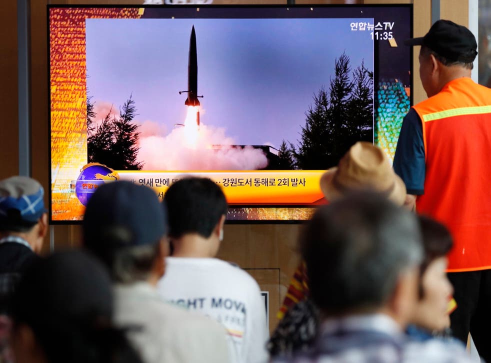 South Korean people watch a breaking news broadcast about North Korea's missile launch in Seoul