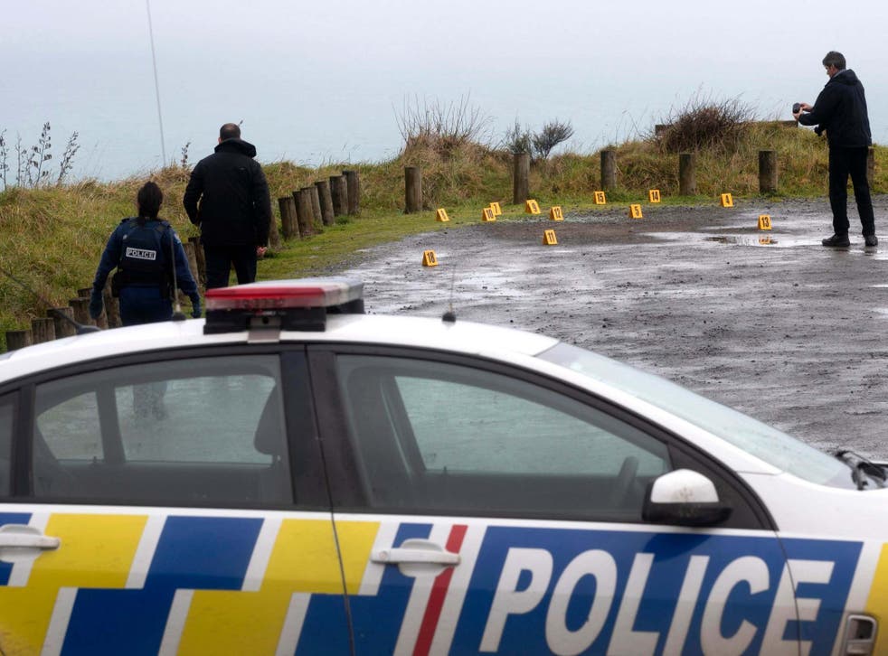Police collect evidence in the car park of the Te Toto Gorge lookout outside Raglan, New Zealand, where a man was shot dead in a camper van