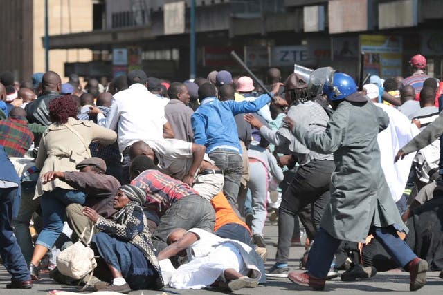 Zimbabwe Republic Police (ZRP) officers clash with members of the public who took part in the Democratic Change (MDC) Alliance organised Peace March in Harare, Zimbabwe