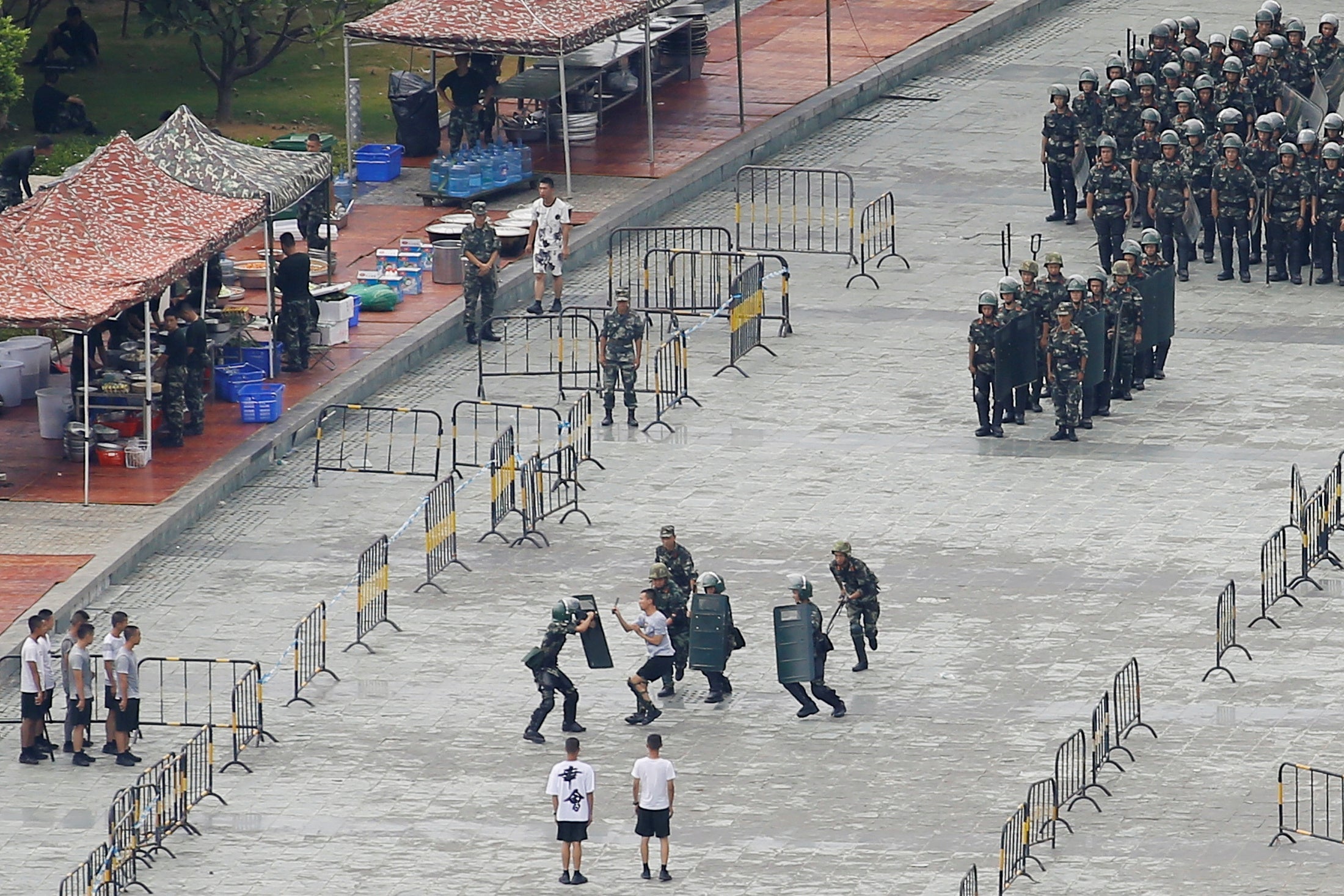 Chinese servicemen attend a crowd control exercise at the Shenzhen Bay stadium on Friday