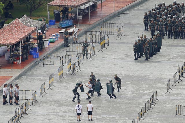 Chinese servicemen attend a crowd control exercise at the Shenzhen Bay Stadium on Friday