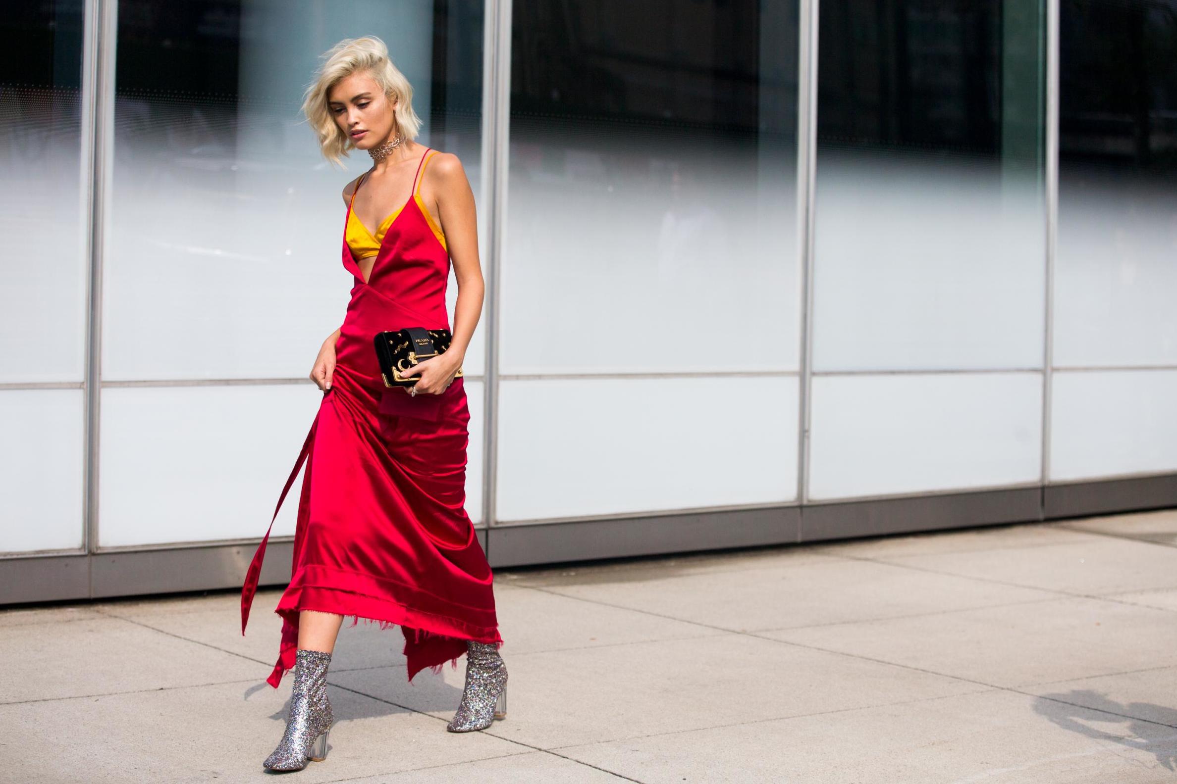 Sarah Ellen in a red slip dress, yellow bra top, Prada wallet, and silver sparkly booties outside the Dion Lee show at Pier 59 on September 10, 2016 in New York City.