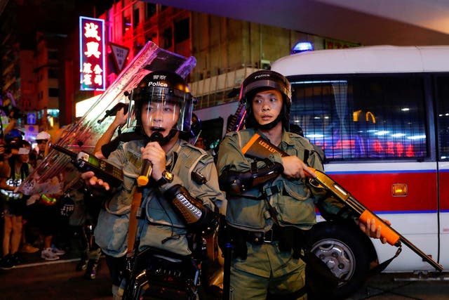 Riot police stand guard after an anti-extradition bill march at Mongkok, in Hong Kong, on 17 August