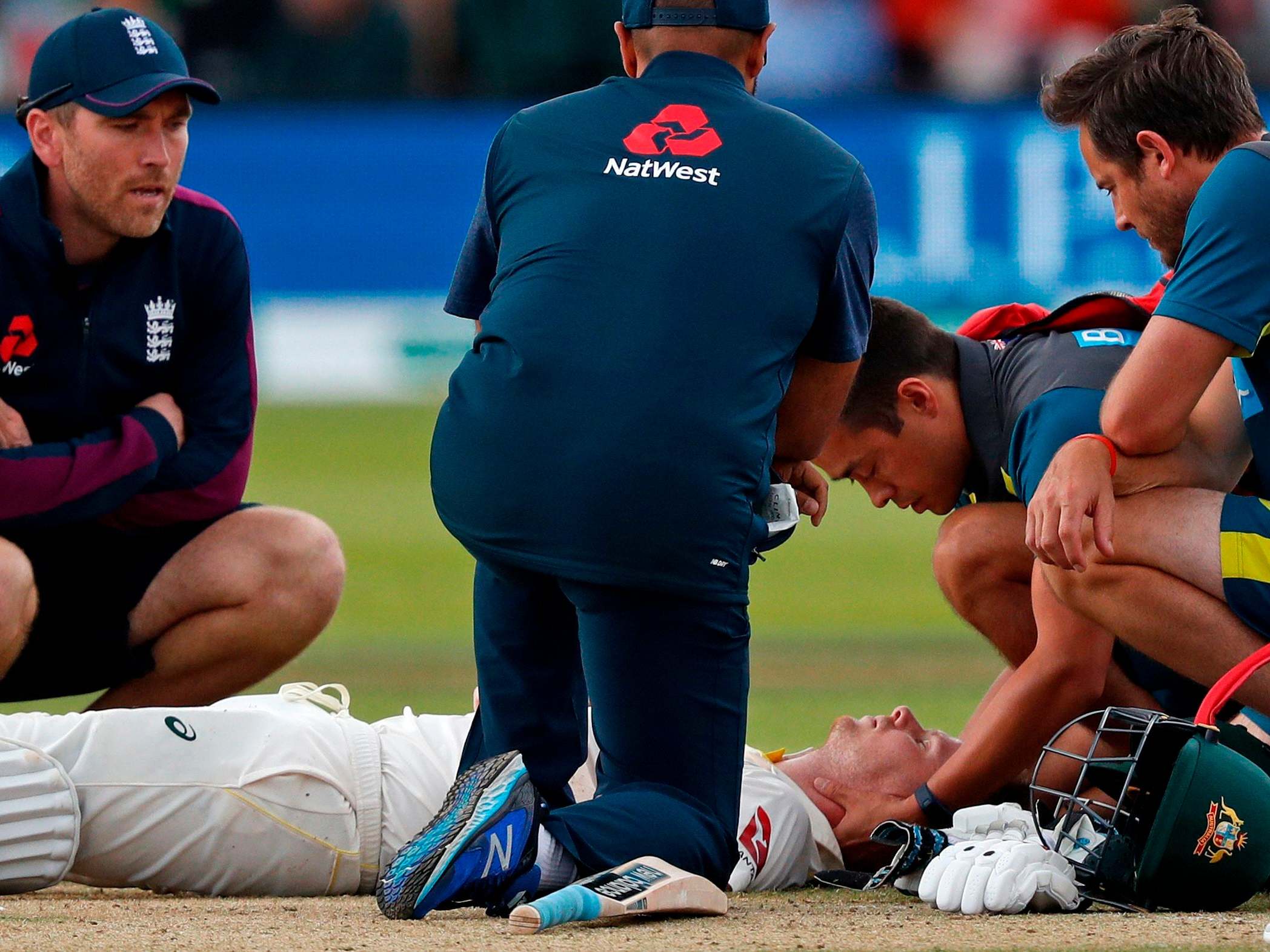 Steve Smith is treated after being struck on the head by Jofra Archer's bouncer