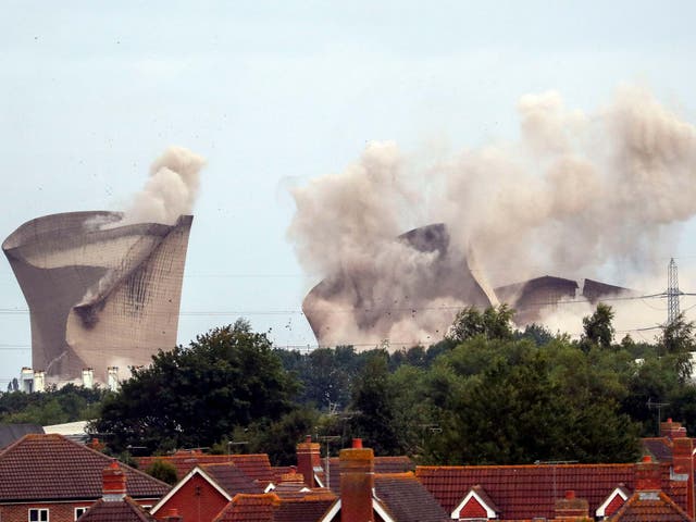 The cooling towers at the disused coal-fired Didcot power station in Oxfordshire are demolished on 18 August 2019.