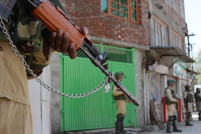 Security personnel stand guard in central Srinagar on the 15th day of lockdown in Kashmir