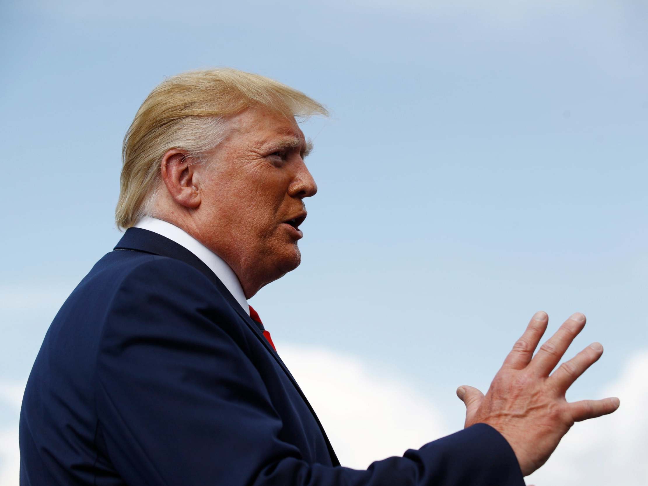 President Donald Trump speaks with reporters before boarding Air Force One at Morristown Municipal Airport