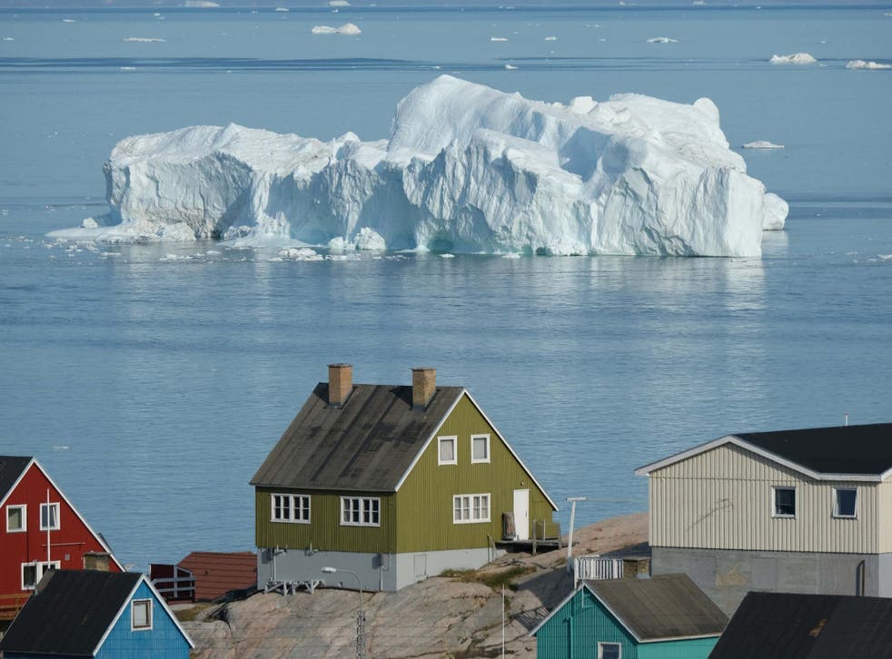 An iceberg floats by in Greenland, where the rate of glacier retreat has accelerated over the past several decades