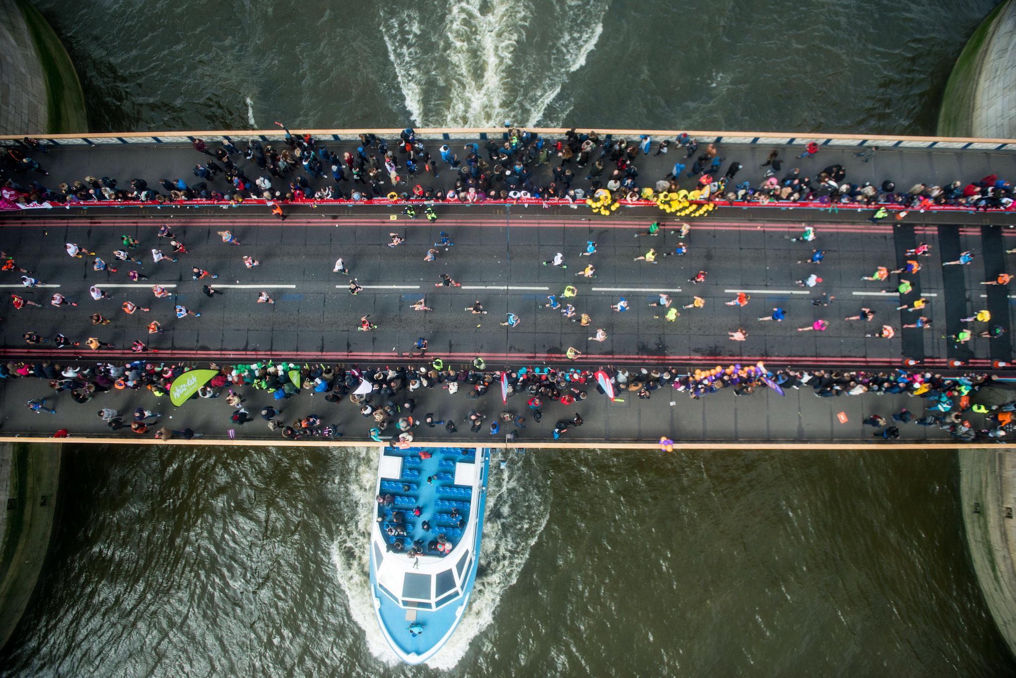 Runners cross over Tower Bridge as seen from the glass floor of Tower Bridge walkway, during the 36th London Marathon at United Kingdom on April 24, 2016 in London, England