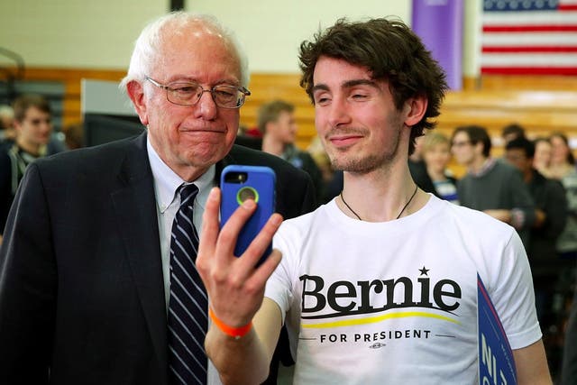 Bernie Sanders takes a selfie with a supporter