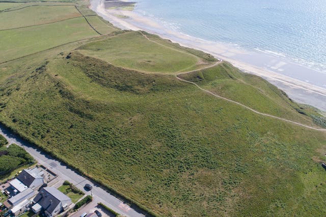 The hill fort overlooks the sea and the Caernarfonshire coastal plain, but is threatened by erosion and the impacts of climate change