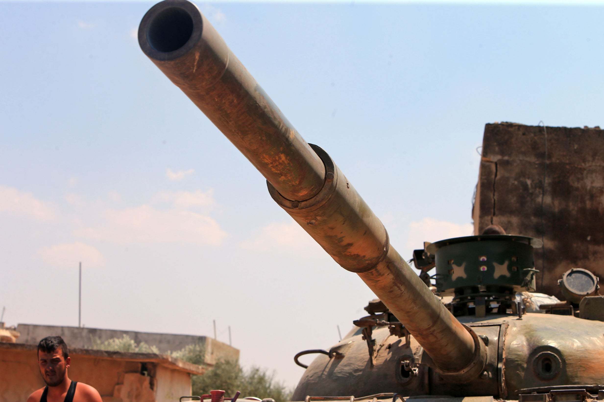 Syrian government forces gather near the town of Khan Shaykhun in the southern countryside of the rebel-held Idlib province