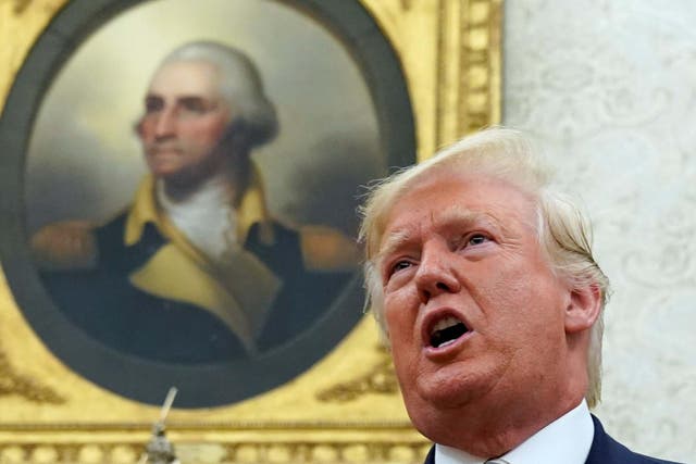 George Washington's portrait looks down on Donald Trump in the Oval Office