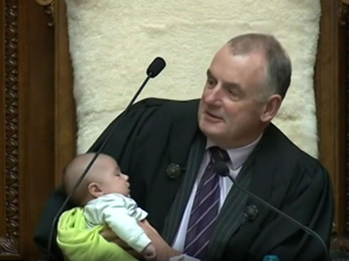 New Zealand speaker of the house Trevor Mallard holding the baby