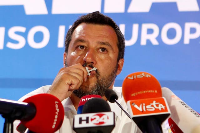 Matteo Salvini kisses a crucifix as he speaks during his European Parliament election night event