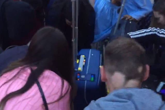Still image taken from video of strangers helping woman pick up 3,200-piece Lego set after she dropped it at London Euston station, 21 August 2019.