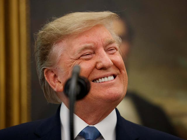 Donald Trump smiles while speaking during a Presidential Medal of Freedom ceremony for former NBA basketball player and coach Bob Cousy of the Boston Celtics in the Oval Office