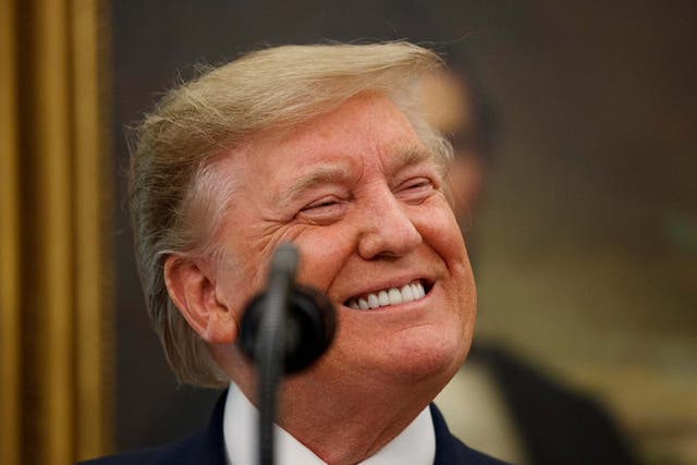 Donald Trump smiles while speaking during a Presidential Medal of Freedom ceremony for former NBA basketball player and coach Bob Cousy of the Boston Celtics in the Oval Office
