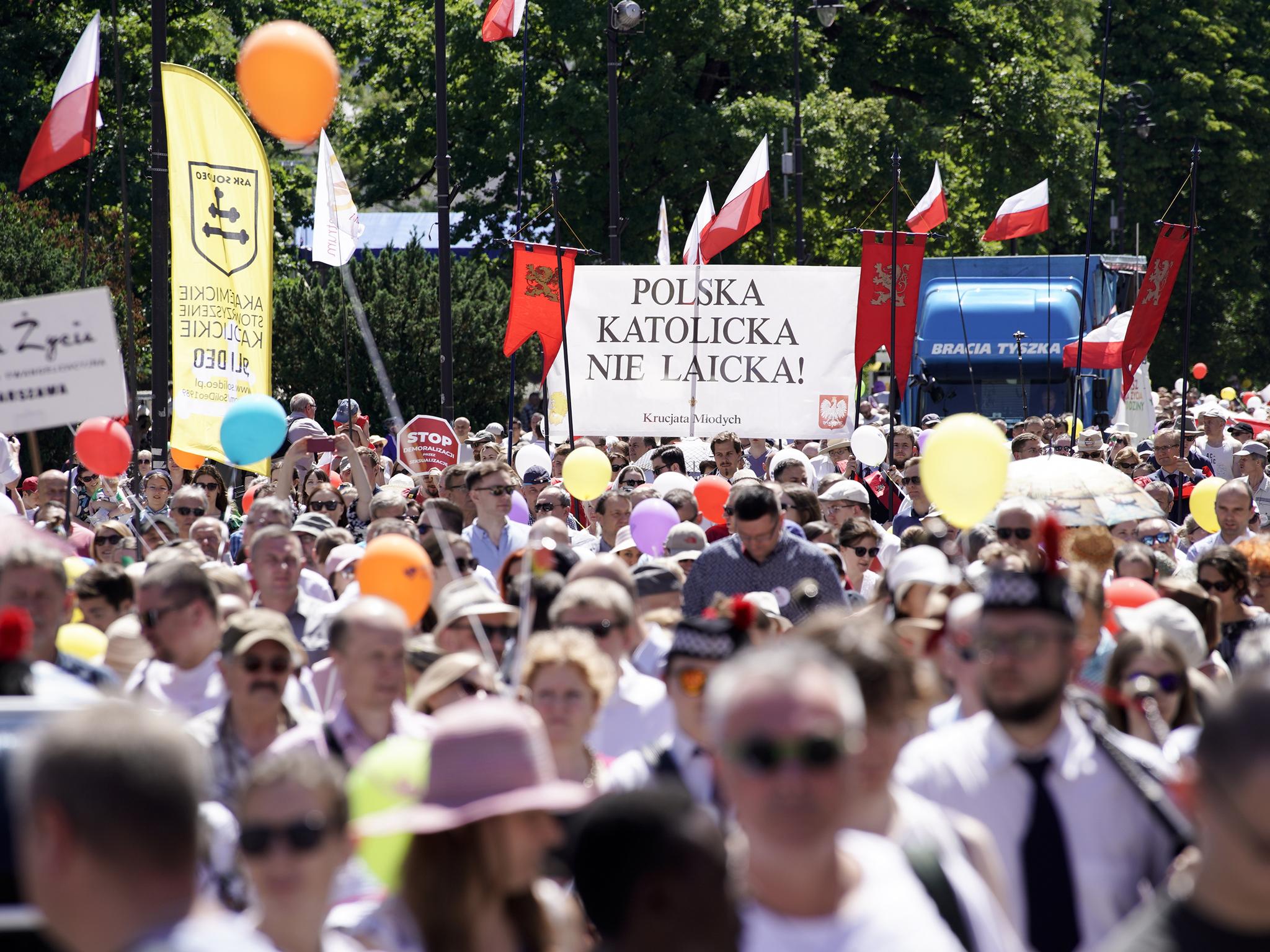 Campaigners in Warsaw in the ‘March for Life and Family’ promote the government’s conservative, anti-LGBT+ views