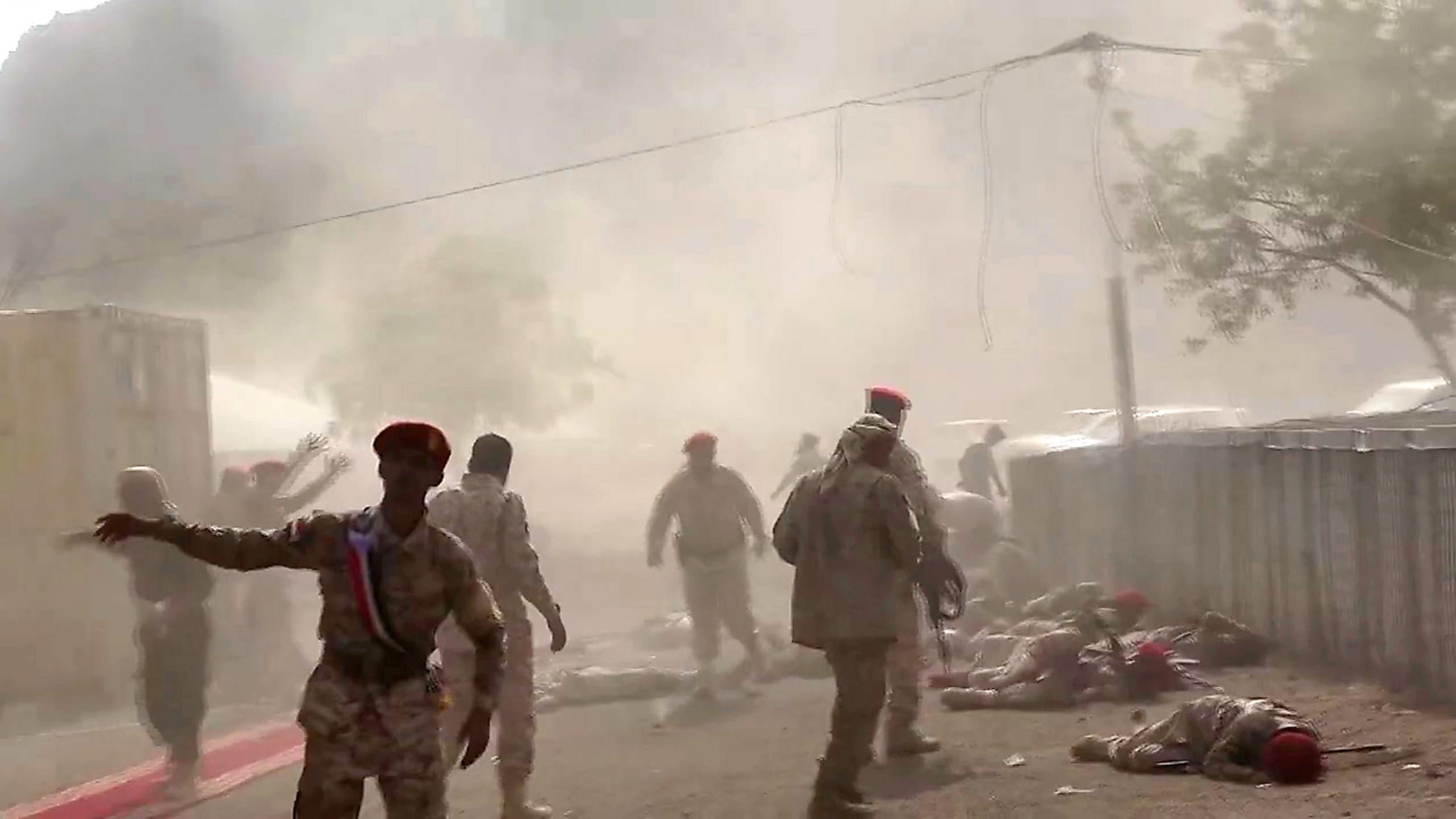 This AFPTV screen grab from a video made on 1 August shows Yemeni security forces rushing at the scene of a missile attack on a military camp west of Yemen’s government-held second city Aden (AFP)