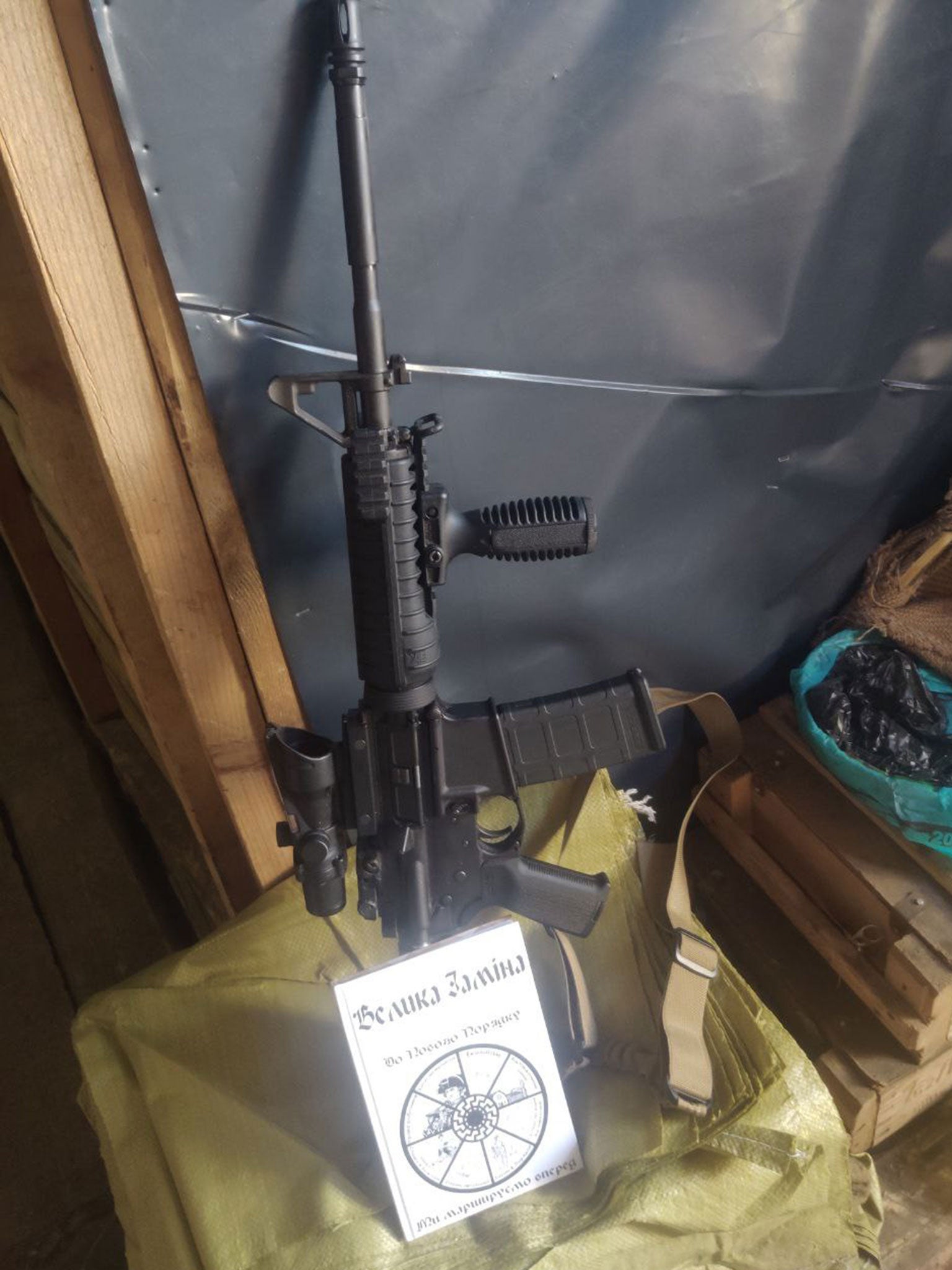 A translated copy of Brenton Tarrant’s manifesto next to a gun, in an image posted on a Ukrainian-language Telegram channel