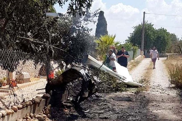 A handout photo made available by the Baleares Fire Brigade (?·iffbaleares) showing debris after a plane and a helicopter collided