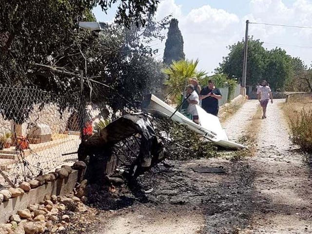 A handout photo made available by the Baleares Fire Brigade (Â·iffbaleares) showing debris after a plane and a helicopter collided