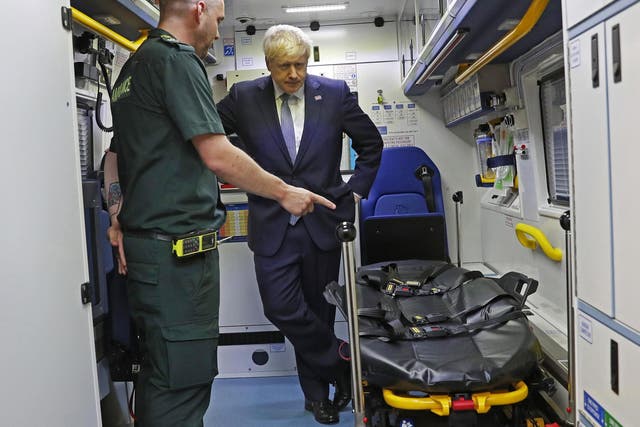 File: Boris Johnson is shown around an ambulance. Cancer Research UK says 'government inaction on staff shortages is crippling the NHS'