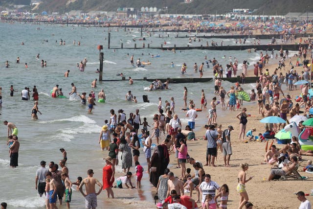 People enjoy the warm weather on Bournemouth beach during the late August bank holiday, 24 August 2019.