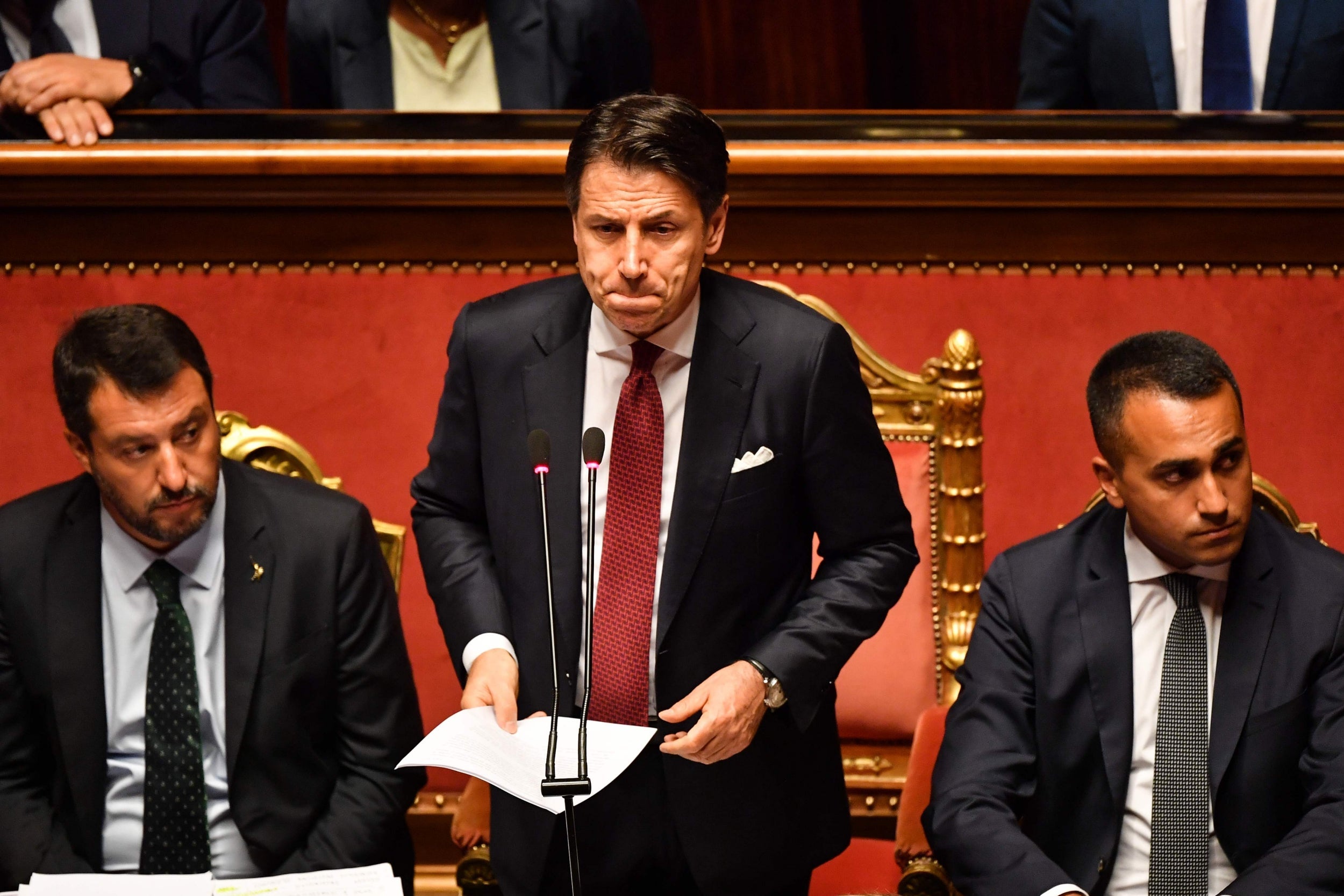 Giuseppe Conte, flanked by Matteo Salvini, left, and Luigi Di Maio, delivers a speech in the Italian Senate last week