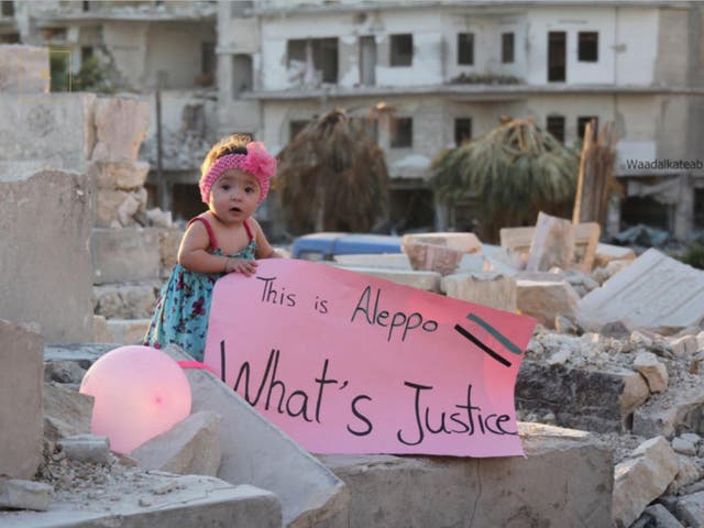 Sama holds a placard in east Aleppo in response to US presidential candidate Gary Johnson’s gaffe ‘What’s Aleppo’