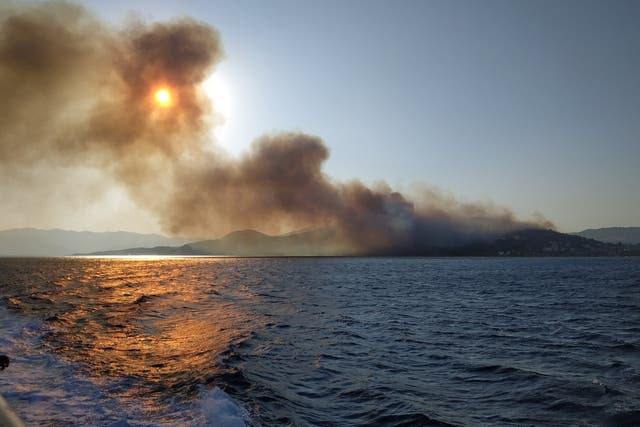 Smoke billows over the sea during a fire on Samos island