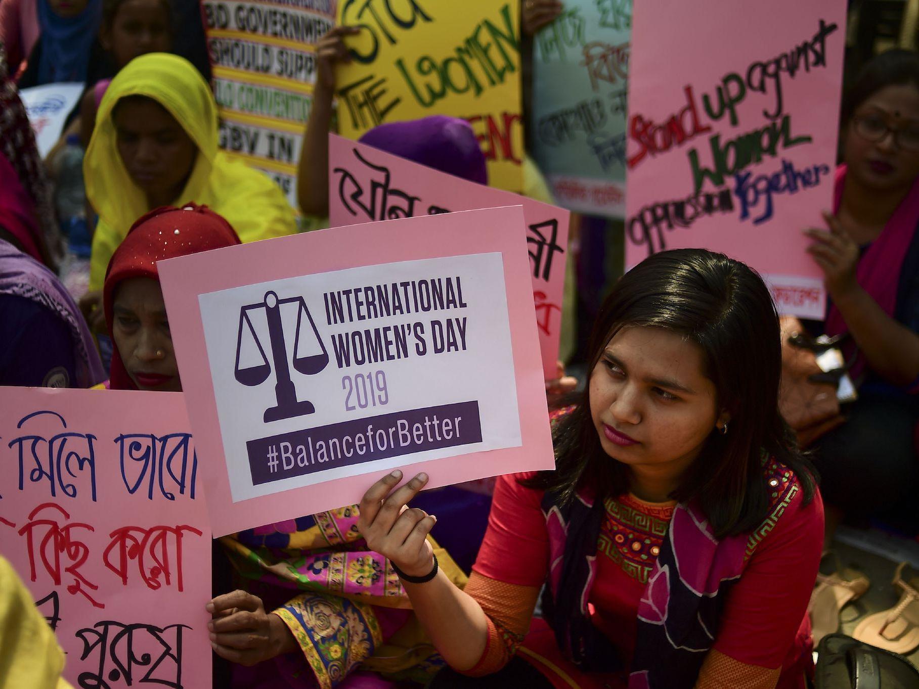 File: Bangladeshi women hold placards as they take part in a rally to mark International Women's Day in Dhaka