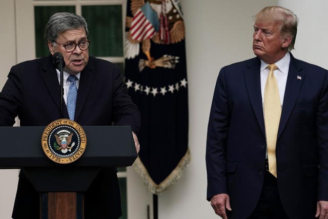 Attorney General William Barr speaks as Donald Trump looks on.