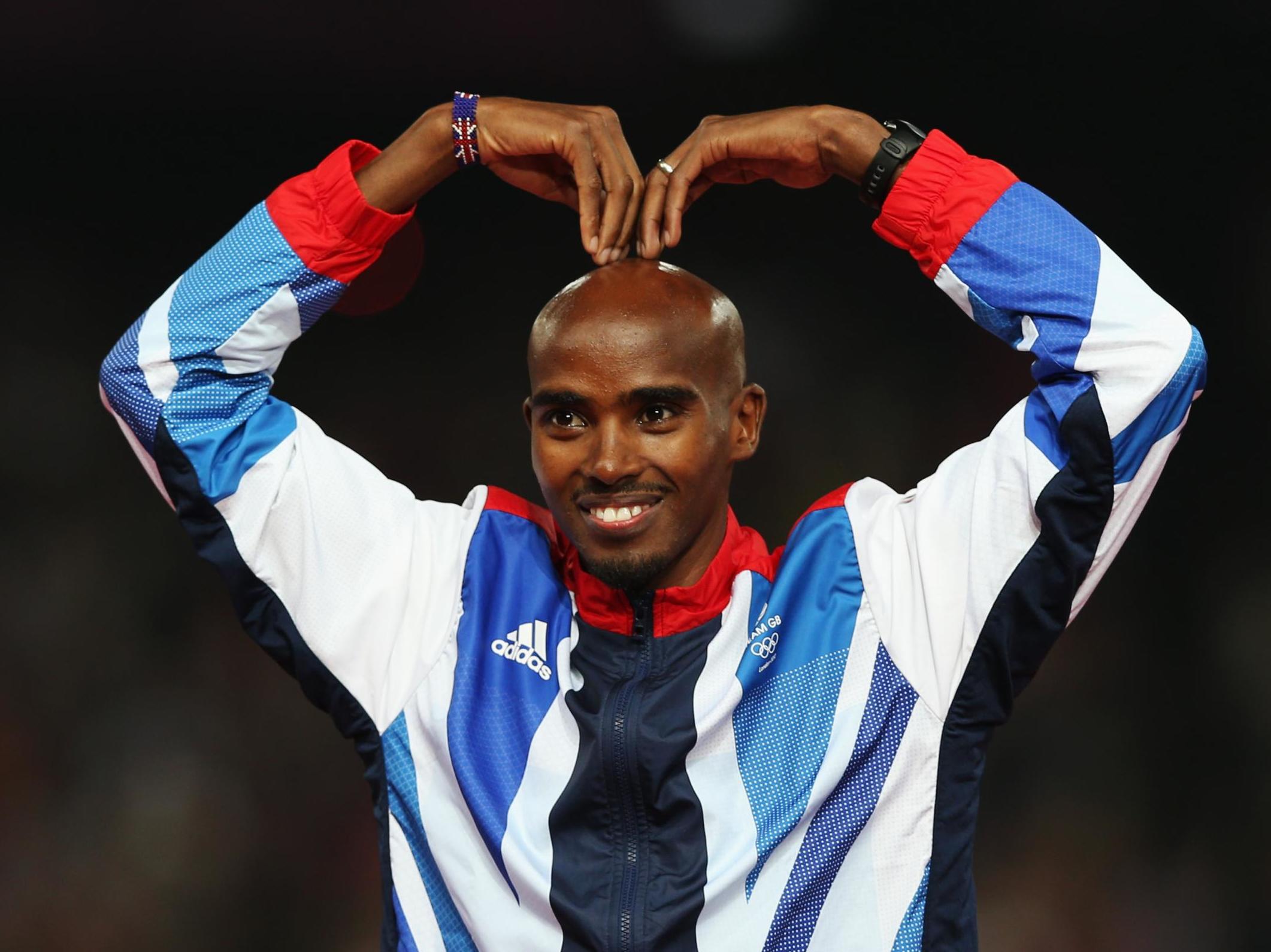 Gold medalist Mohamed Farah of Great Britain celebrates on the podium during the medal ceremony for the Men's 5000m on Day 15 of the London 2012 Olympic Games at Olympic Stadium on August 11, 2012 in London, England