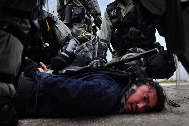 Riot police detain a protester at Kowloon Bay in Hong Kong