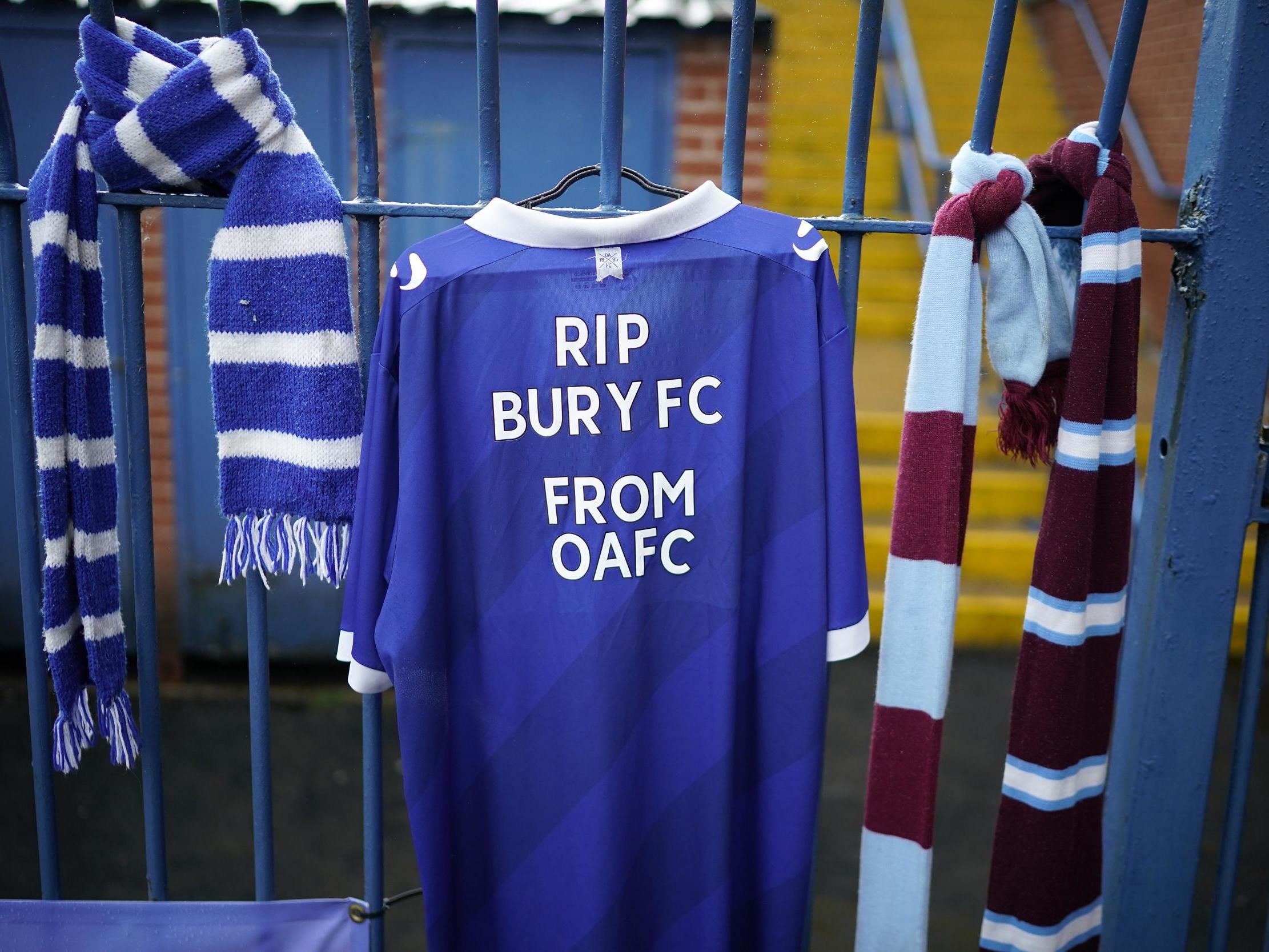 Shirts and scarves are draped outside Bury’s stadium